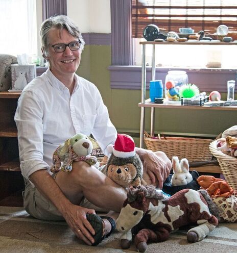 Todd Hedinger in his office with therapy toys